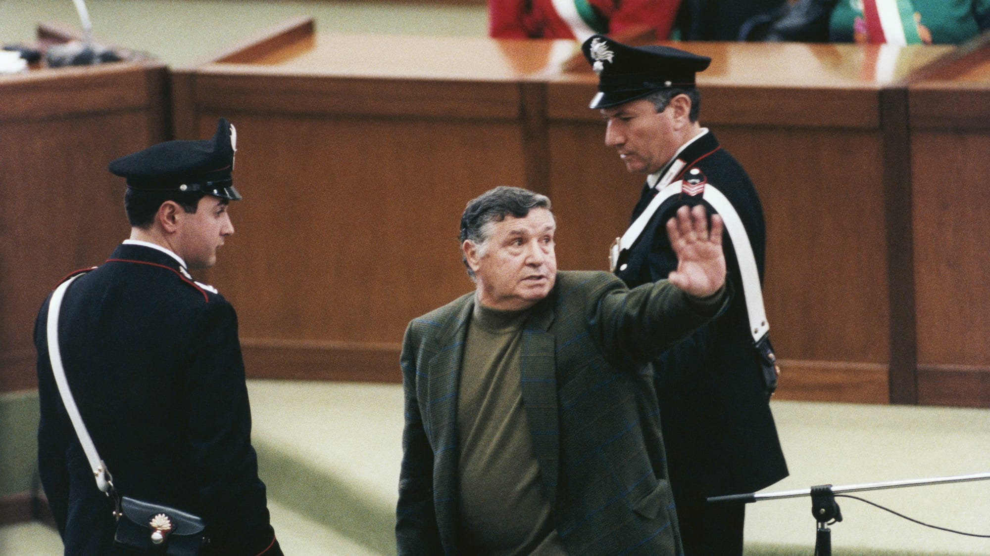 Salvatore "Totò" Riina, the notorious chief of the Sicilian Mafia (Cosa Nostra) inside an Italian courtroom in 1993, shortly after he received one of his 26 life sentences. 